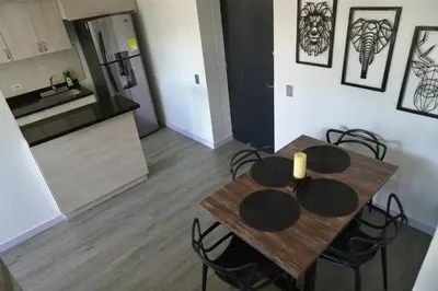a dining room table and chairs in a kitchen at Apartamento Las Vegas Plaza in Sabaneta
