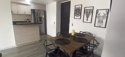 a dining room table and chairs in a kitchen at Apartamento Las Vegas Plaza in Sabaneta