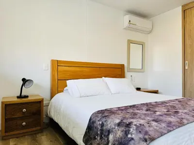 a bedroom with a large bed with a wooden headboard at Amazing apartment in Poblado in Medellín