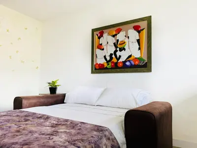 a bedroom with a bed and a painting on the wall at Amazing apartment in Poblado in Medellín