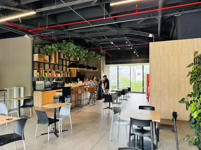 a restaurant with tables and chairs and people in the background at Amazing apartment in Poblado in Medellín