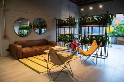 a living room with a couch and a table and chairs at Amazing apartment in Poblado in Medellín