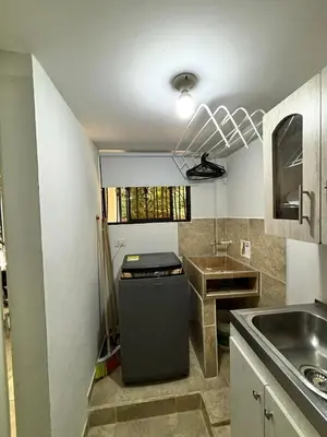 a small kitchen with a sink and a refrigerator at Apartamentos Bello Antioquia in Bello