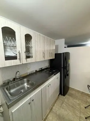 a kitchen with a sink and a refrigerator at Apartamentos Bello Antioquia in Bello