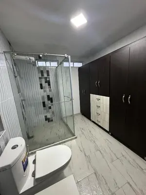 a bathroom with a toilet and a glass shower at LA CASONA Finca Hostal in Apía