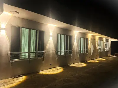 a row of windows on a building at night at LA CASONA Finca Hostal in Apía