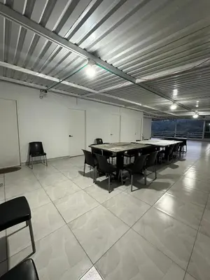 a large room with a table and chairs in it at LA CASONA Finca Hostal in Apía