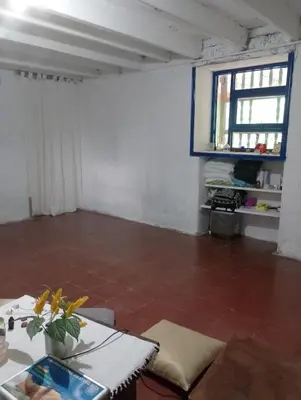 an empty room with a table and a window at Habitación en casa de campo via al aeropuerto in Copacabana