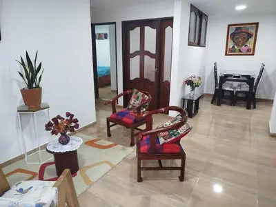 a living room with two chairs and a table at Hospedaje temporal in Carmen de Viboral