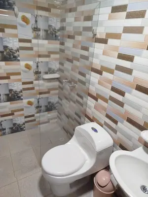 a bathroom with a toilet and a sink at Hospedaje temporal in Carmen de Viboral