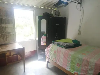 a bedroom with a bed and a dresser and a window at Ermita del tinte in San Rafael