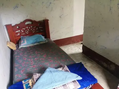 a small bedroom with a bed with blue sheets at Ermita del tinte in San Rafael
