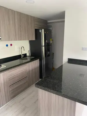 a kitchen with a sink and a refrigerator at Apto nuevo, tranquilo y central in Manizales