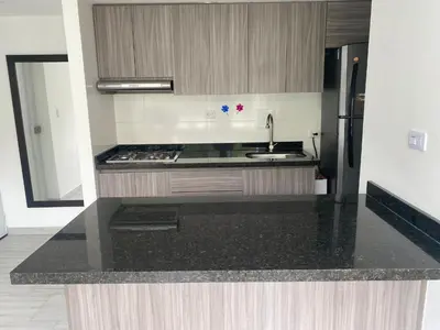 a kitchen with a sink and a refrigerator at Apto nuevo, tranquilo y central in Manizales