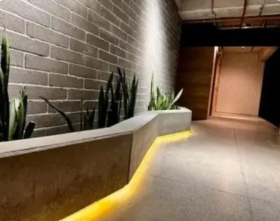 a hallway with plants and a brick wall at Hermoso Loft in Medellín