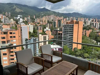 two chairs and a table on a balcony with a city at Great view 3 bedroom apartment near Provenza 1101 in Medellín