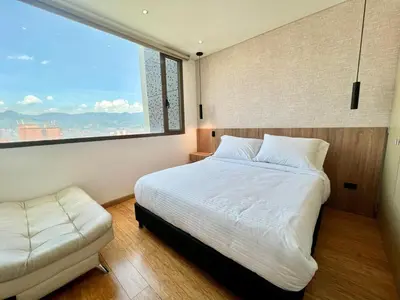 a bedroom with a bed and a large window at Great view 3 bedroom apartment near Provenza 1101 in Medellín