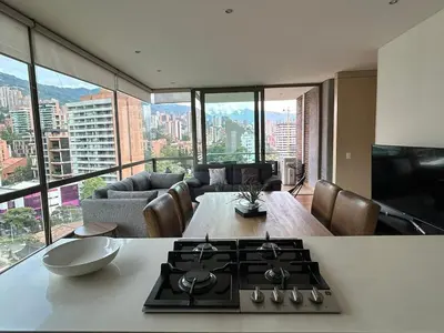 a kitchen with a stove top in a living room at Amazing 3 bedroom near Provenza- El Poblado 701 in Medellín