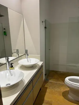 a bathroom with two sinks and a toilet at Amazing 3 bedroom near Provenza- El Poblado 701 in Medellín
