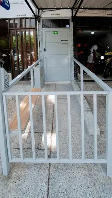 a white door in a building with a fence at Hotel Boutique Casa Teresita in Medellín