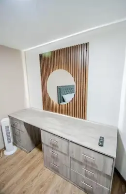a desk in a room with a mirror on the wall at Hotel Boutique Casa Teresita in Medellín