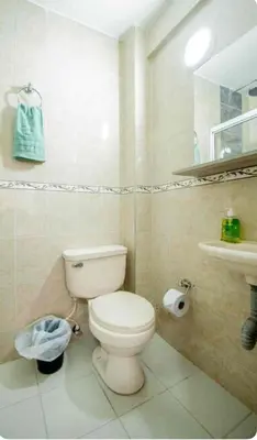 a bathroom with a toilet and a sink at Hotel Boutique Casa Teresita in Medellín