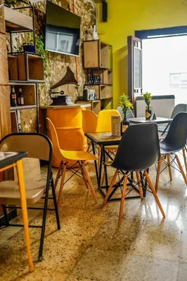 a group of chairs and tables in a room at Panela Hostel Poblado in Medellín