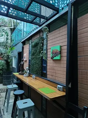 a patio with a bar with stools in front of it at Panela Hostel Poblado in Medellín