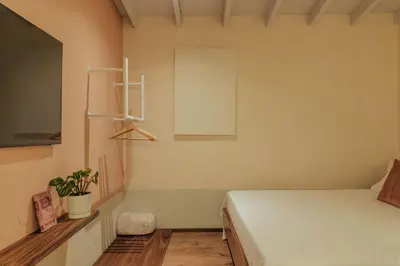 a bedroom with a bed and a plant on a shelf at New designed Loft in Laureles with AC and WiFi in Medellín