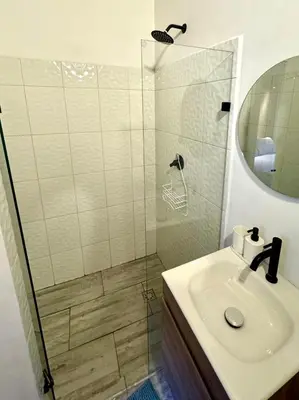 a bathroom with a sink and a shower at Lucia Metro House in Medellín