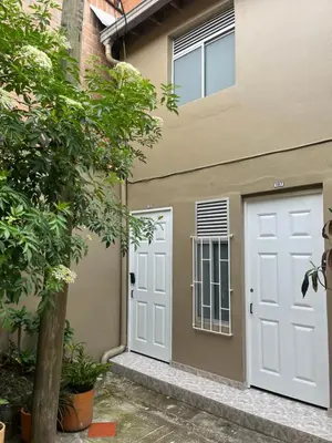 a pair of white doors on the side of a building at Lucia Metro House in Medellín