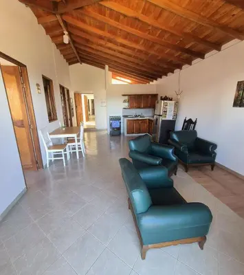a living room with a couch and chairs and a kitchen at aparta hotel La Gruta Jericó, apartamento con balcón in Jericó