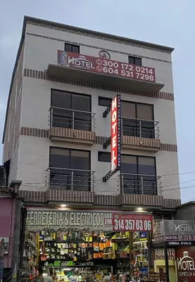 a tall building with a store in front of it at Hotel Olimpo La 47 in Rionegro