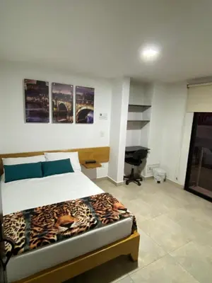 a bedroom with a bed with a leopard blanket on it at Hotel Olimpo La 47 in Rionegro