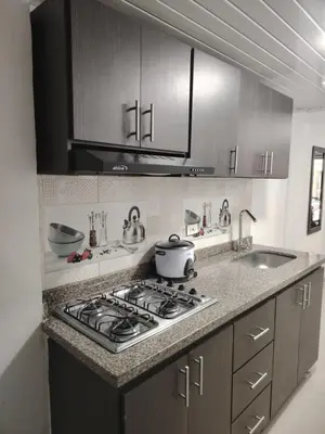 a kitchen with a stove and a sink at Aparta estudio amoblado en Chinchiná Caldas Eje Cafetero in Chinchiná
