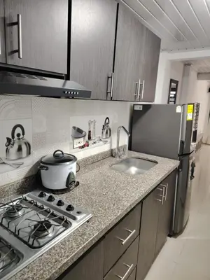 a kitchen with a stove top and a sink at Aparta estudio amoblado en Chinchiná Caldas Eje Cafetero in Chinchiná