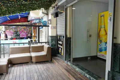 a couch sitting on a porch of a building at Hotel Serymar la 70 in Medellín
