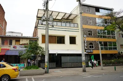 a yellow car parked in front of a building at Hotel Serymar la 70 in Medellín