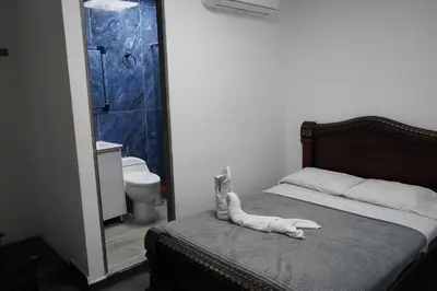 a bedroom with a bed with a phone on it at Hotel Serymar la 70 in Medellín