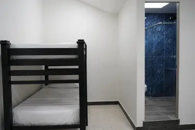 a bunk bed in a room with a shower at Hotel Serymar la 70 in Medellín