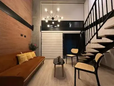 a living room with a couch and a staircase at Loft hermoso y céntrico 1109 in Medellín