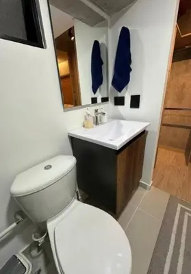 a bathroom with a white toilet and a sink at Loft hermoso y céntrico 1109 in Medellín