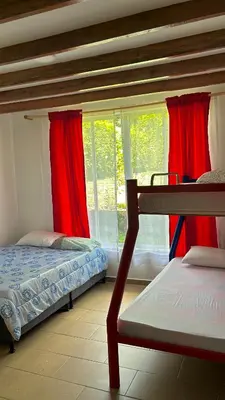 a bedroom with two bunk beds and a window at Casa Campestre La Mesita in Palestina