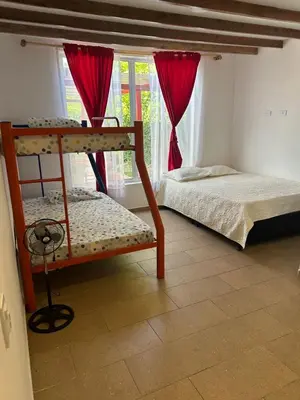 a bedroom with two bunk beds and a window at Casa Campestre La Mesita in Palestina