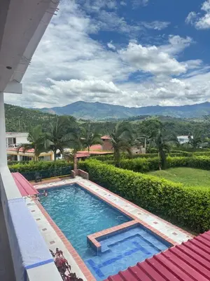 a swimming pool with a view of the mountains at Casa Campestre La Mesita in Palestina