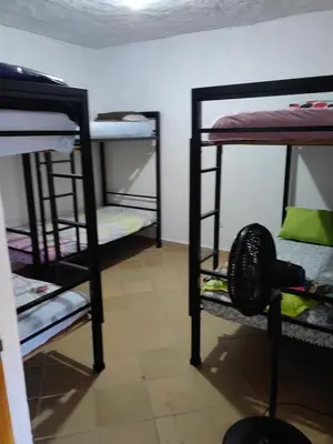 a room with three bunk beds in a room at Finca de Rubén in Olaya