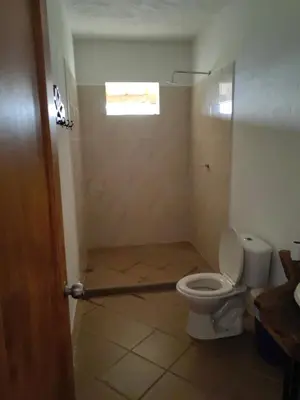 a bathroom with a toilet and a window at Finca de Rubén in Olaya
