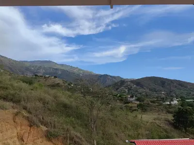 a view of a hill with mountains in the background at Finca de Rubén in Olaya