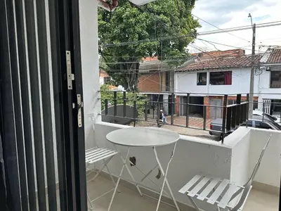 a white table and chairs on a balcony with a view at loft dreams 7006 in Medellín