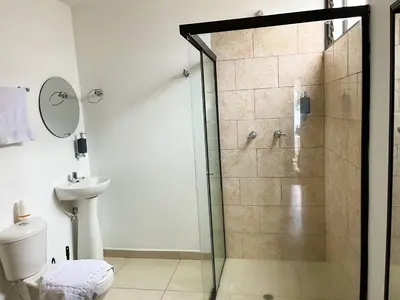a bathroom with a shower with a toilet and a sink at loft dreams 7006 in Medellín